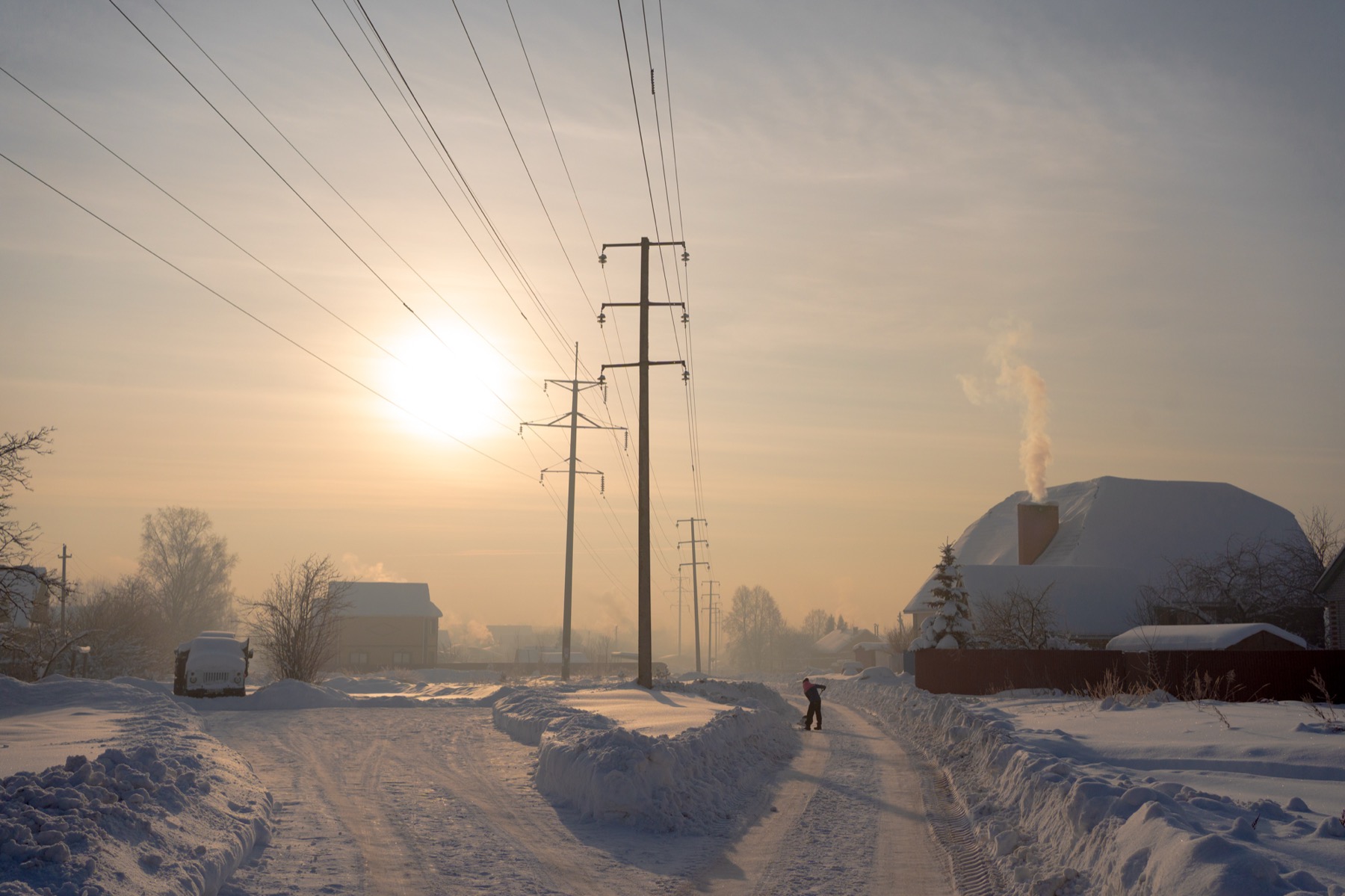Winter village road in low sun